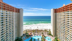 A high-rise hotel with a view of a beach and a swimming pool. - Shores of Panama 1816 (Panama City Beach)