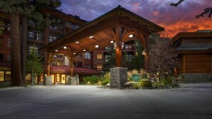 A lodge with a wooden pavilion, stone pillars, and a red-roofed building. - Studio next to Gondola 1 (South Lake Tahoe)
