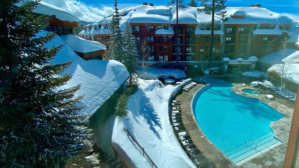 A resort with a pool, snow-covered surroundings, and buildings with multiple stories. - Studio next to Gondola 1 (South Lake Tahoe)