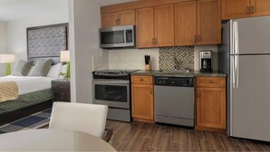 A modern kitchen with stainless steel appliances, wooden cabinets, and a tiled backsplash. - Studio next to Gondola 1 (South Lake Tahoe)