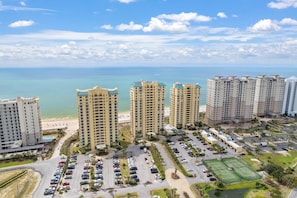 Residents enjoy stunning beachfront views from their high-rise apartments with balconies.