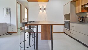 Eine moderne Küche mit einer zentralen Kochinsel, Edelstahlgeräten und einem minimalistischen Design.