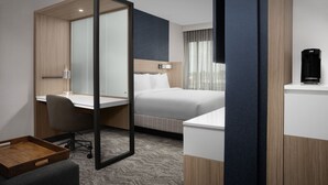 A modern hotel room with a bed, a desk, a chair, a mirror, and a coffee maker. - Springhill Suites by Marriott Lexington Fritz Farm (Lexington)