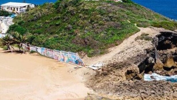 A coastal landscape with a lighthouse, sandy beach, clear turquoise waters, and rocky outcrops. - Coastal Paradise Steps from Secluded Beaches & Stunning views in Islote, Arecibo (Islote)