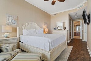 Cozy retreat with a large bed, nightstand, and flat-screen TV.