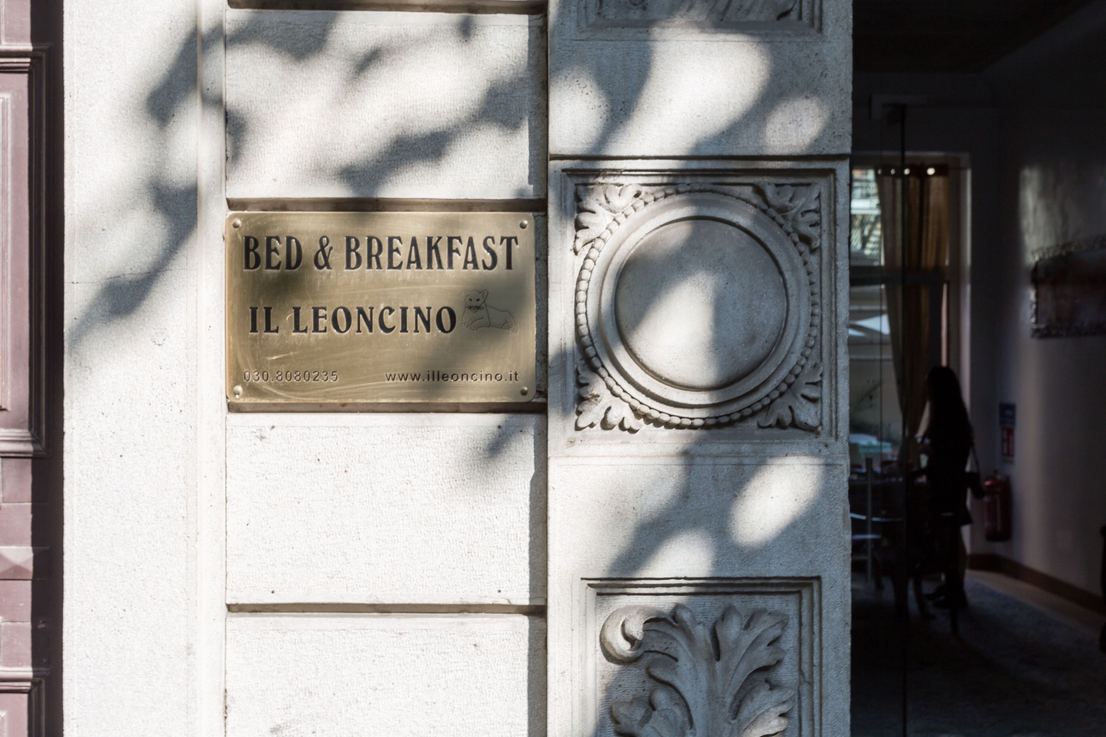Una placa en la pared de un edificio que dice "BED & BREAKFAST IL LEONCINO" con una dirección web.