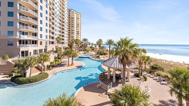 A resort with a swimming pool, beach view, and multiple floors of residential buildings. - Indigo West 301 (Pensacola)