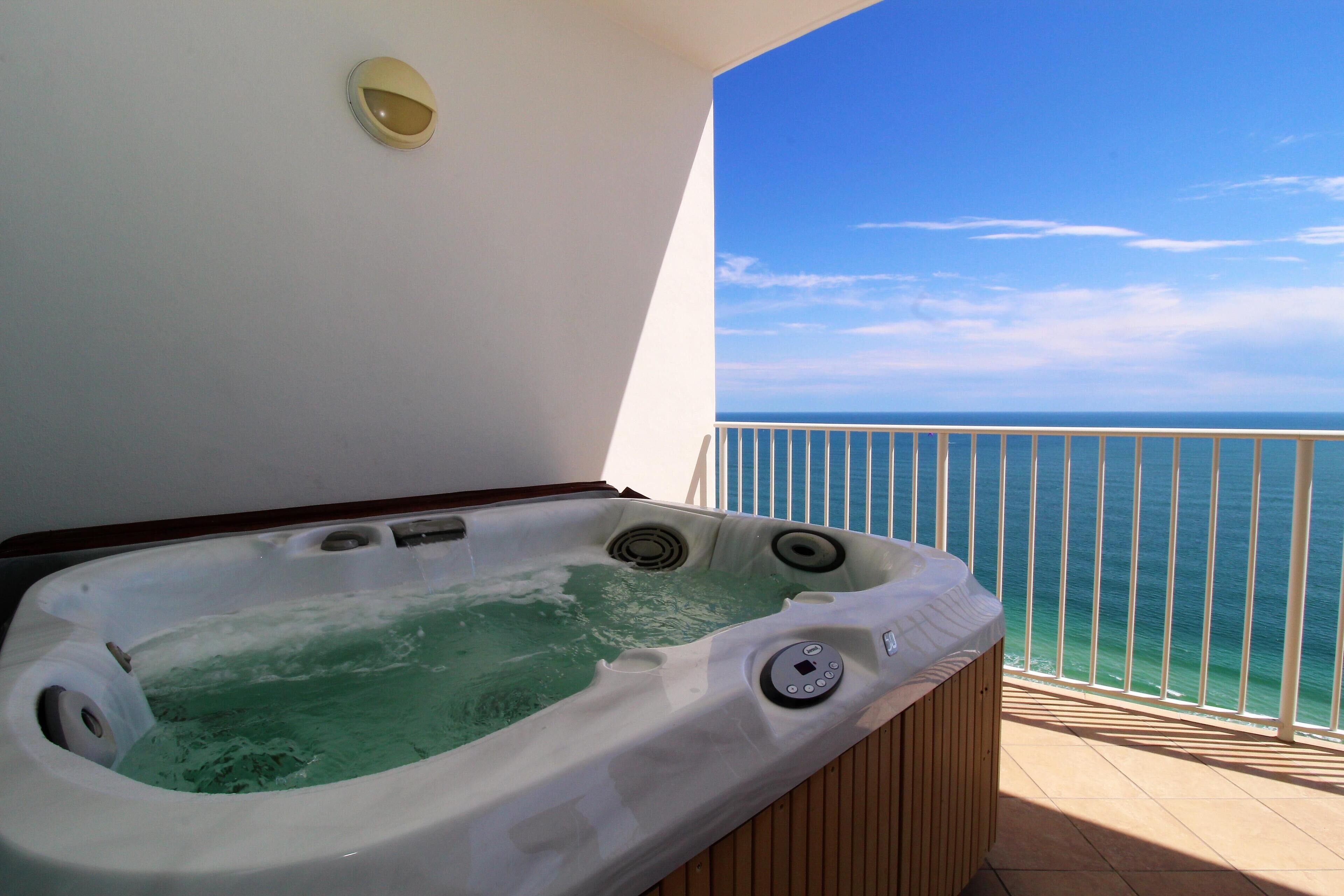 A hot tub on a balcony with a view of the ocean.