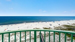 A beach with a clear view of the ocean and a green railing in the foreground. - Perdido Towers West 908 (Pensacola)