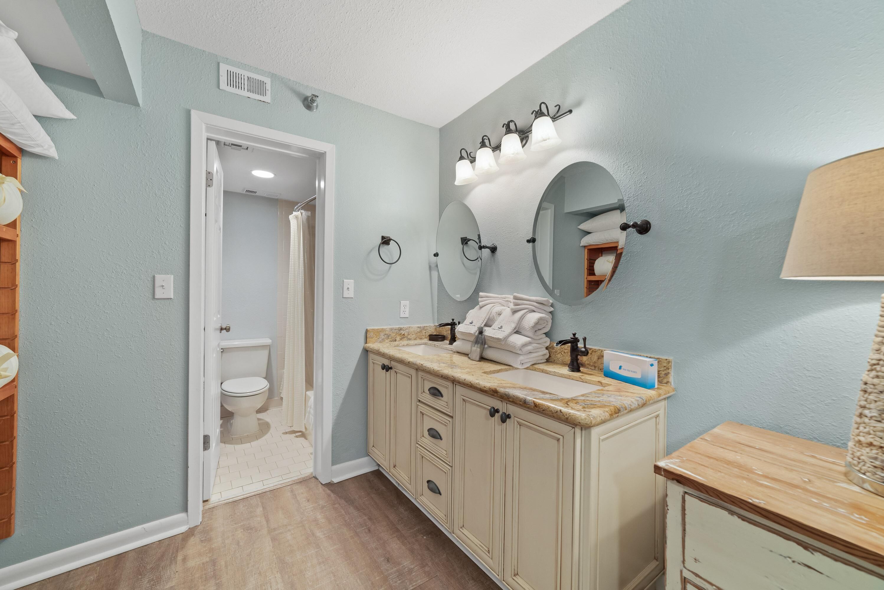 A bathroom with a sink, mirror, and toilet.