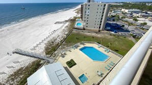 A high-rise hotel with a swimming pool, beach access, and a parking area. - Perdido Sun 904 (Pensacola)