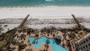 A resort with a large pool area, palm trees, and a beach. - Indigo East 1906 (Pensacola)