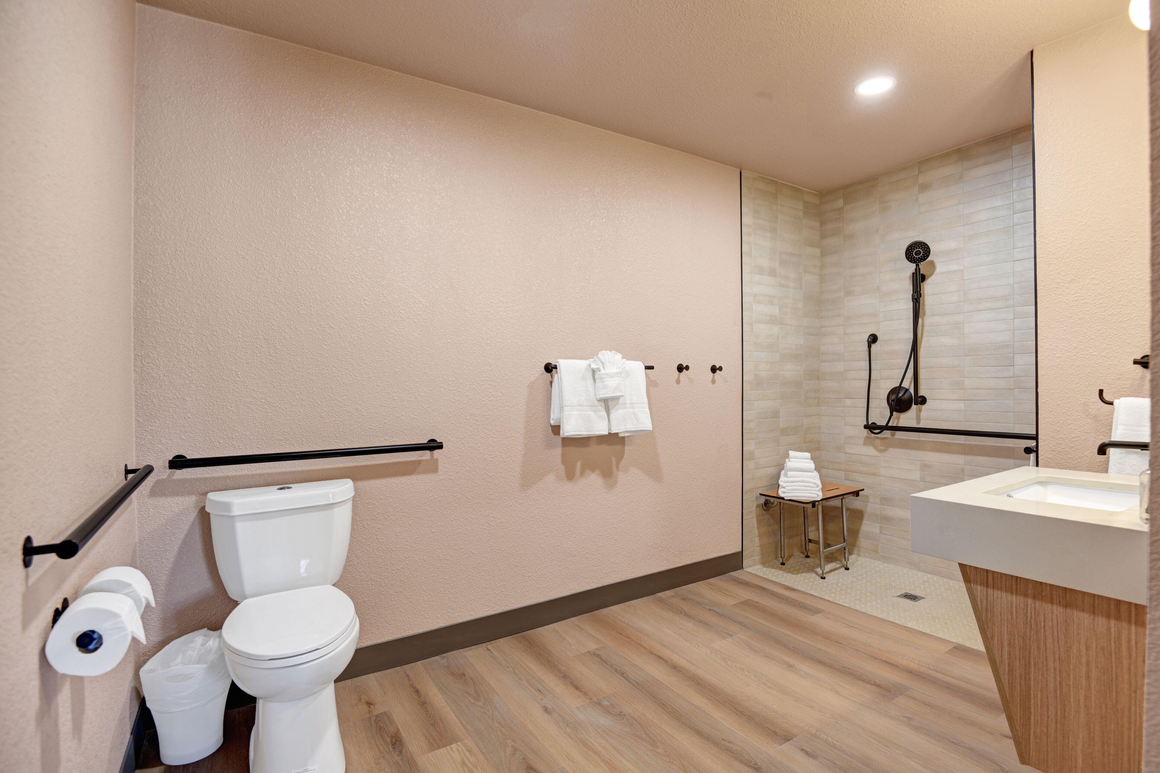 A modern bathroom with a toilet, bidet, and shower.