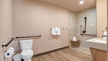 A modern bathroom with a toilet, bidet, and shower.