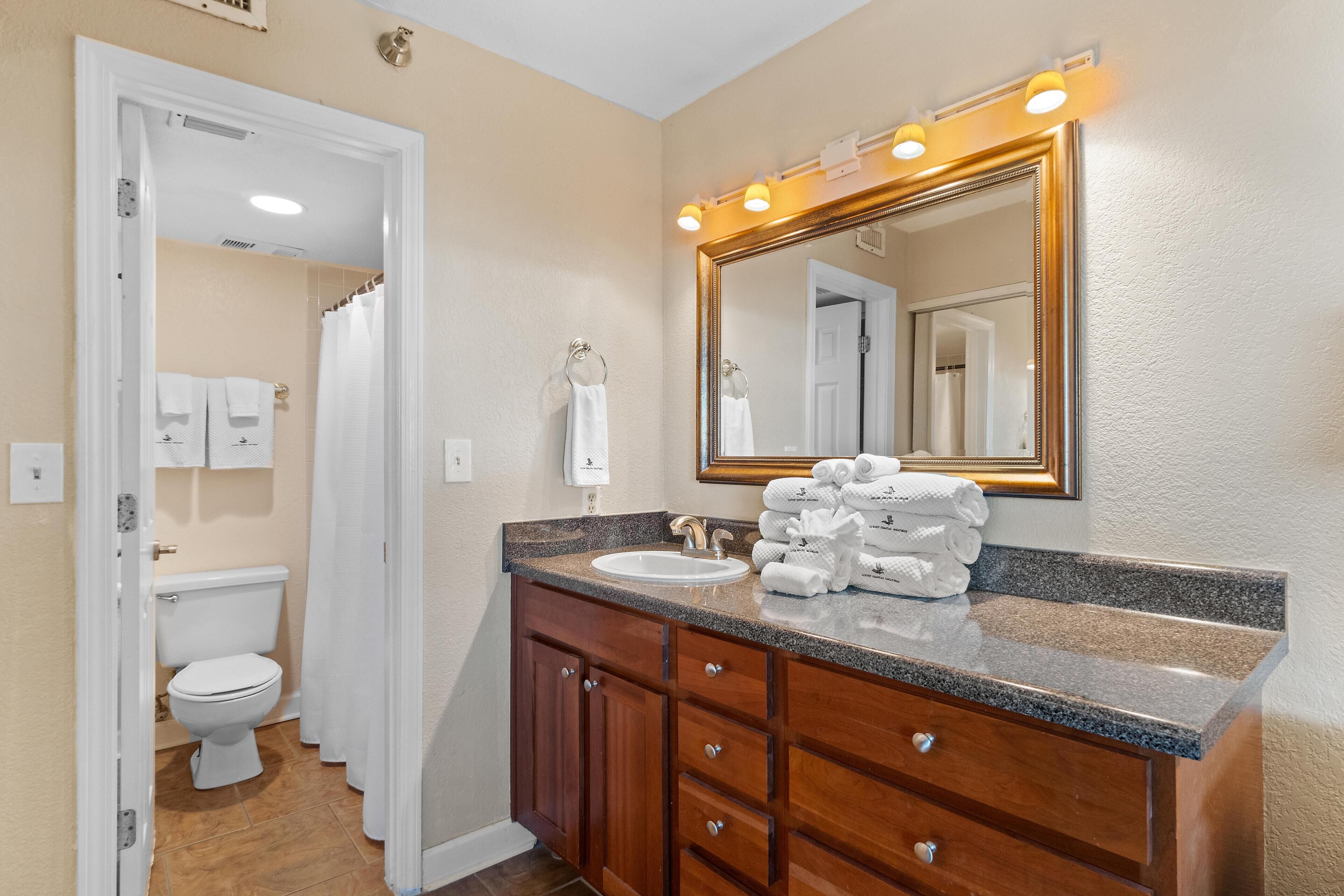 A bathroom with a sink, mirror, and towel rack.