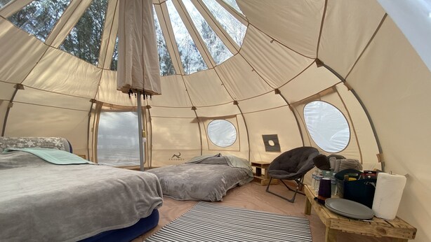A cozy tent with two beds, a small table, and a chair. - Farmstay Glamping AGRItourism retreat-HERSHEYS HUT-cows, chicks, goat, minihorse (Tallahassee)