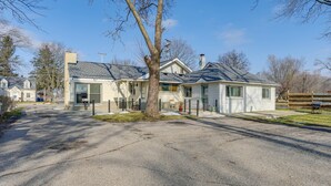 A residential house with a garage, a driveway, and a lawn.