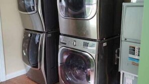 A laundry room with stacked washer and dryer units.