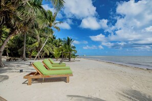 Playa privada, arena blanca, sillas reclinables de playa