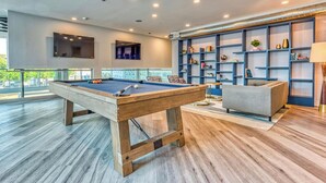 A pool hall lounge with a pool table, seating area, and bookshelves. - Dual Master Bedroom Penthouse in Marina Del Rey, CA (Marina del Rey)