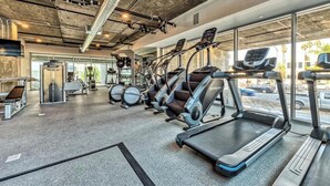 A gym with treadmills, weight machines, and a mirror. - Dual Master Bedroom Penthouse in Marina Del Rey, CA (Marina del Rey)