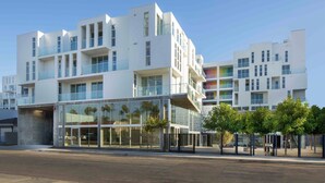 A modern multi-story building with large windows and balconies, likely a hotel or apartment complex. - Dual Master Bedroom Penthouse in Marina Del Rey, CA (Marina del Rey)