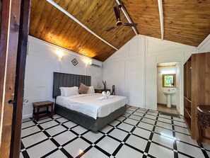 Cozy retreat with a large bed, checkered floor, and ceiling fan.
