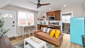 A compact living space with a kitchenette, a dining area, and a seating area with a sofa and a coffee table. - Welcome to the Boar's Nest, walking distance to Noblesville town square  (Noblesville)