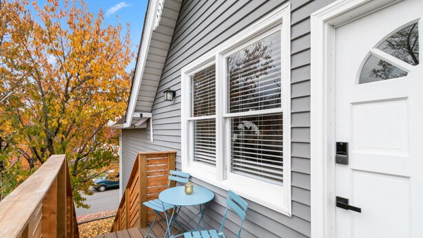 A deck with a table and chairs, a wooden fence, and a house with a white door and windows. - Welcome to the Boar's Nest, walking distance to Noblesville town square  (Noblesville)