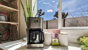 A coffee maker on a kitchen counter with a window view. - Stargazer Ranch - Stunning 5 BR + Hot Tub, Pool, Fire Pit (Yucca Valley)