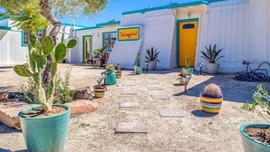 A courtyard with potted cacti and a sign for 'The Ranch'. - Stargazer Ranch - Stunning 5 BR + Hot Tub, Pool, Fire Pit (Yucca Valley)