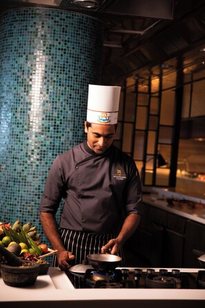 A chef in a kitchen with a tiled backsplash and a stove. - ITC Ratnadipa, a Luxury Collection Hotel, Colombo (Colombo)