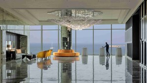 A spacious lobby with a reflective floor, a large chandelier, and a view of the sea through expansive windows. - ITC Ratnadipa, a Luxury Collection Hotel, Colombo (Colombo)