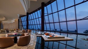 A modern hotel lobby with a large glass wall offering a view of the ocean. - ITC Ratnadipa, a Luxury Collection Hotel, Colombo (Colombo)