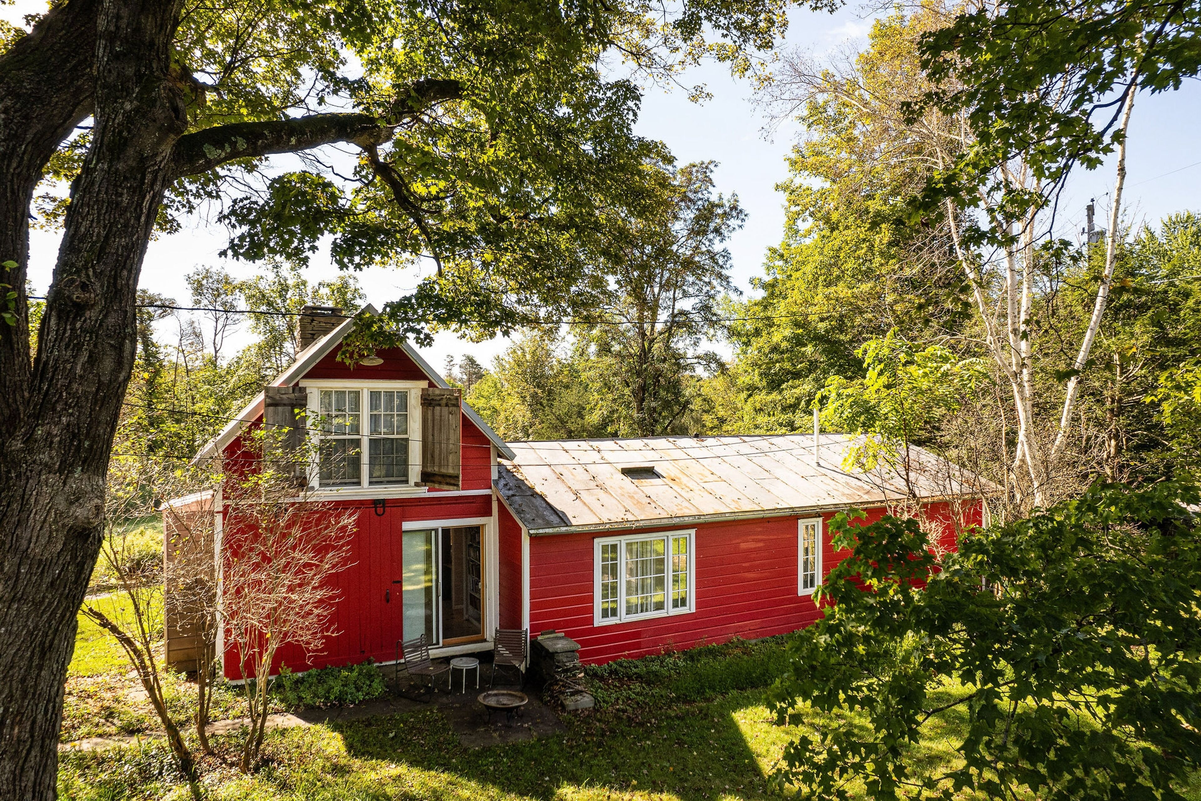 Historic stone house & barn on 10 acres with patio, fireplace, & antique charm