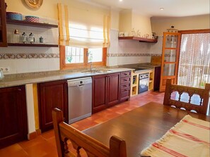 Enjoy meals in this well-equipped kitchen with a central island, stove, and dishwasher.