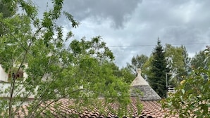 A traditional house with a tiled roof, white walls, and wooden shutters. - Capivento   typical Apulian trullo in the countryside (CEGLIE MESSAPICA)