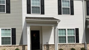 A two-story residential building with a front porch, a brick foundation, and a number '15' sign. - Cozy Stylish 1 Room at New Townhome in Welcoming Fuquay Varina with WiFi, Desk (FUQUAY VARINA)