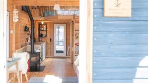 A wooden interior with a kitchen, a dining area, and a staircase. - Holiday Home 'Besonderes Tiny Hausboot Marianne' with Private Terrace and Wi-Fi (Hamburg)