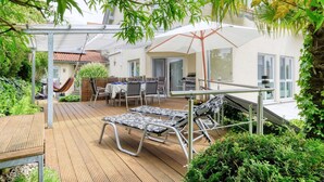 A patio with outdoor furniture, a barbecue grill, and a covered seating area. - Holiday Apartment 'Iris und Uwe' with Mountain View, Private Terrace and Wi-Fi (Markdorf)
