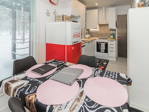 A compact kitchen with a refrigerator, a microwave, and a stove. - Hillaniitty by Interhome (Kuusamo)
