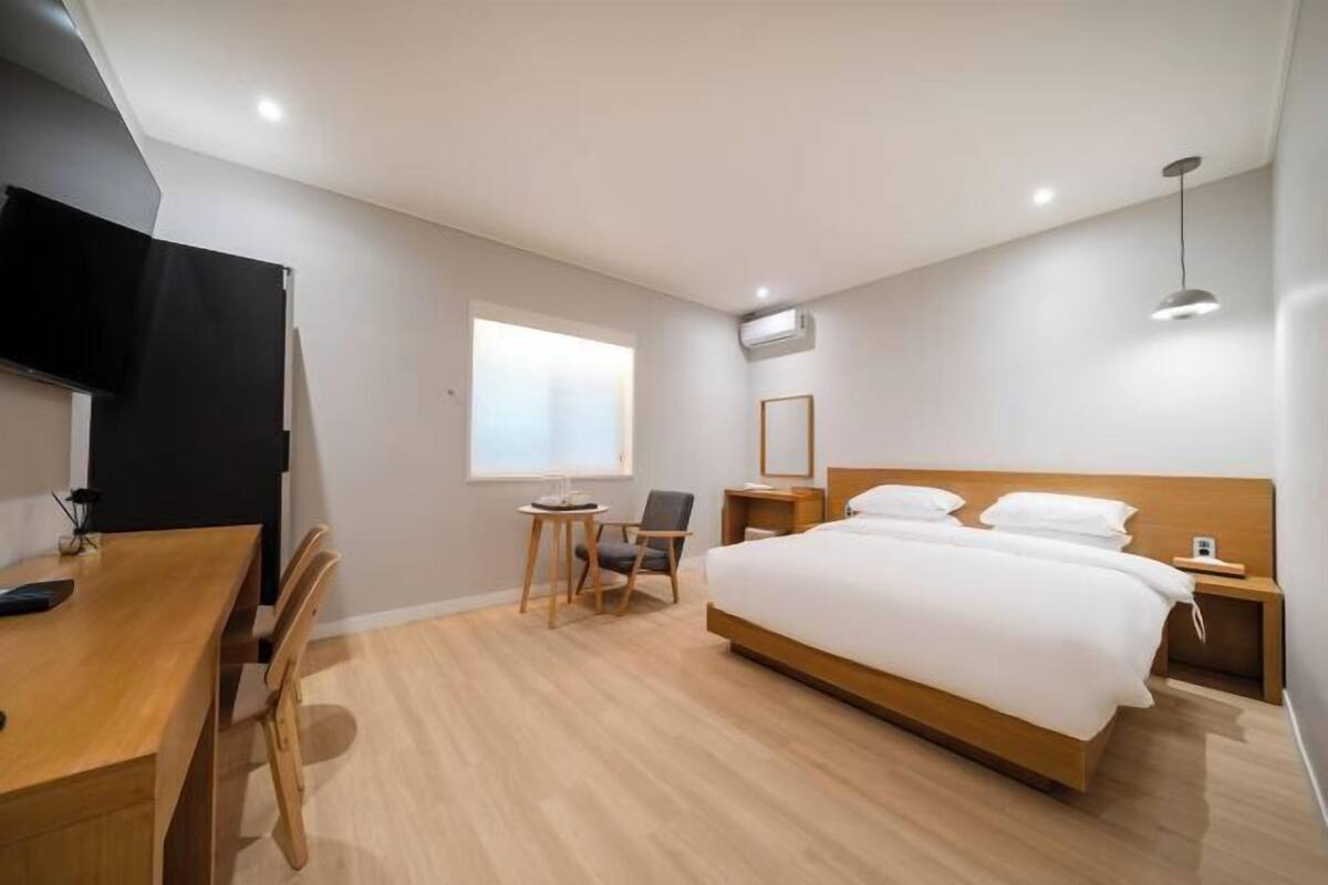 Premium bedding, desk, laptop workspace, soundproofing