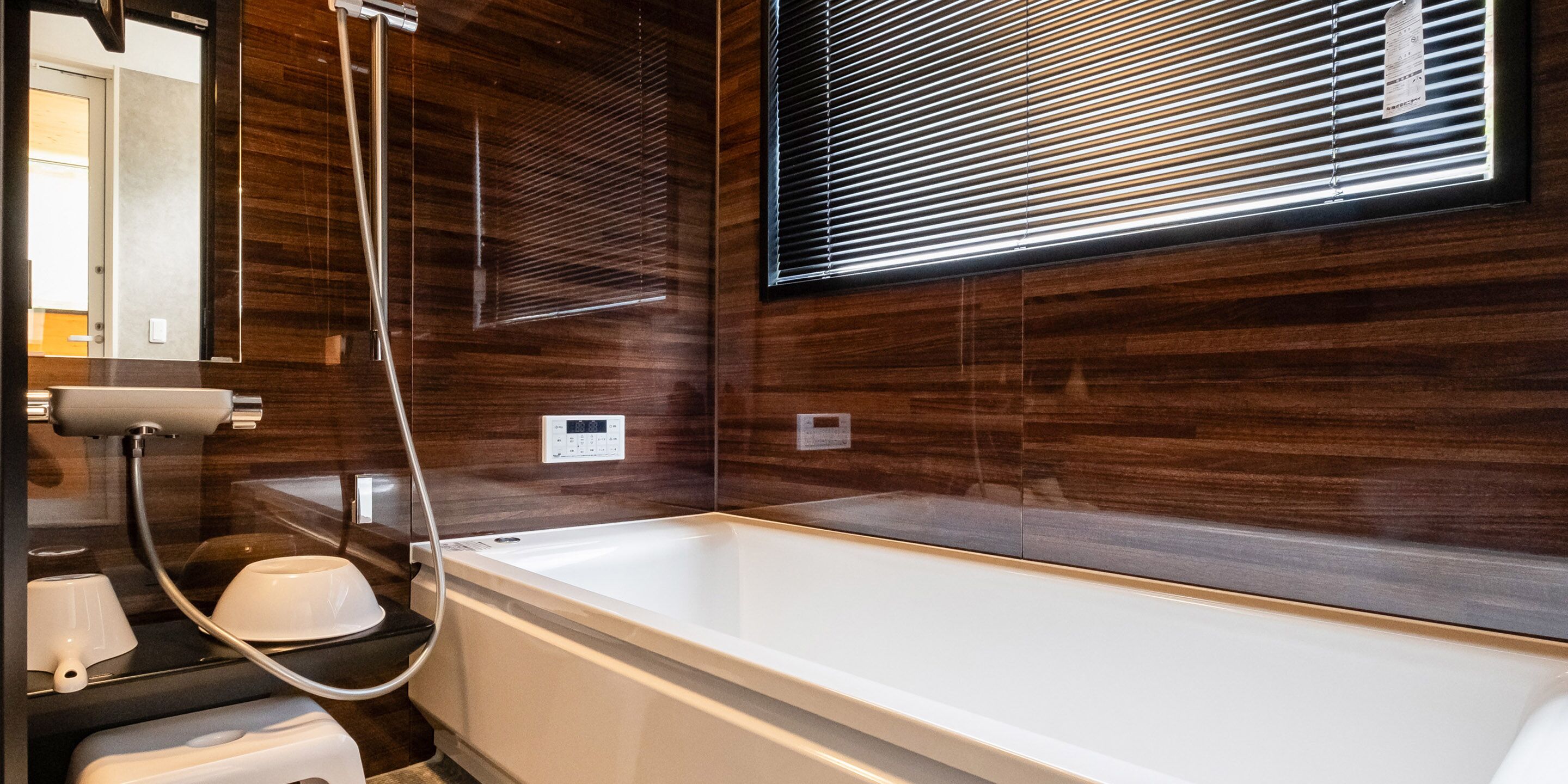 A modern bathroom with a large bathtub, a shower, and a vanity with a mirror.