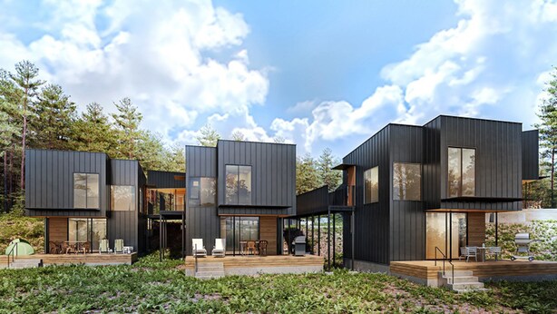 Una casa moderna de varios pisos con un balcón y zona de estar al aire libre, rodeada de un bosque.