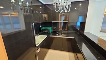 Suite Twin Family | Private kitchen | Fridge, electric kettle, dining tables