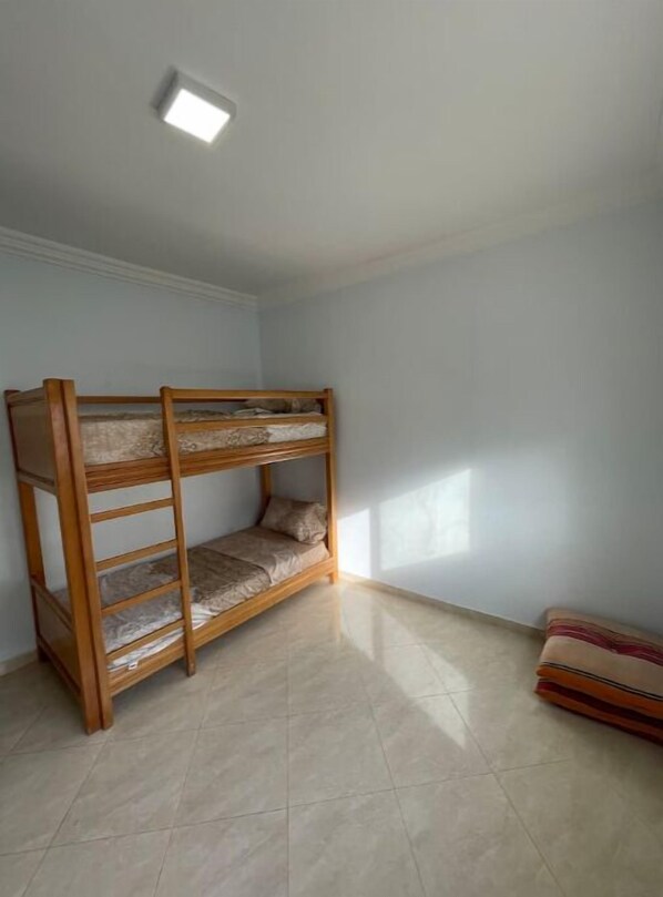 Cozy retreat with a bunk bed and a comfortable cushion.