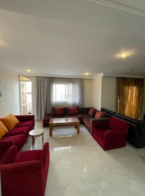 Relax in this stylish living room with a sofa, armchairs, and coffee table.