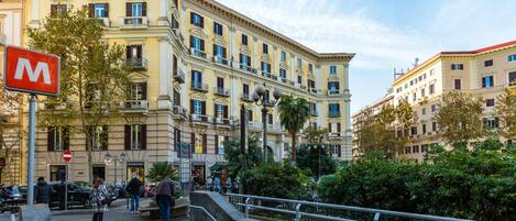 A multi-story building with a classical architectural style, featuring balconies and large windows.