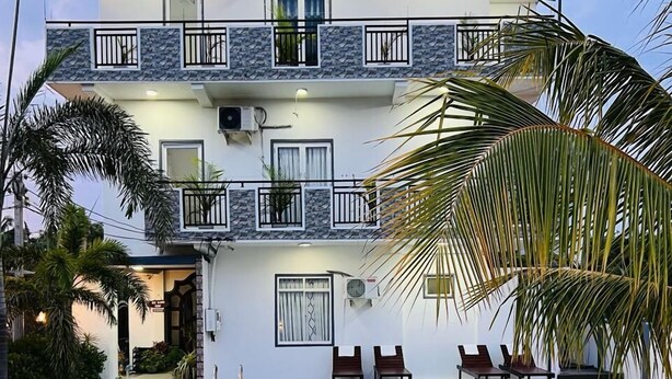 A two-story building with a swimming pool, outdoor seating, and a patterned tile floor. - Blue Diamond Resort (Trincomalee)