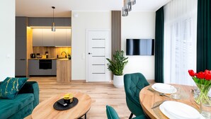 A modern apartment with a kitchen, dining area, and living room.